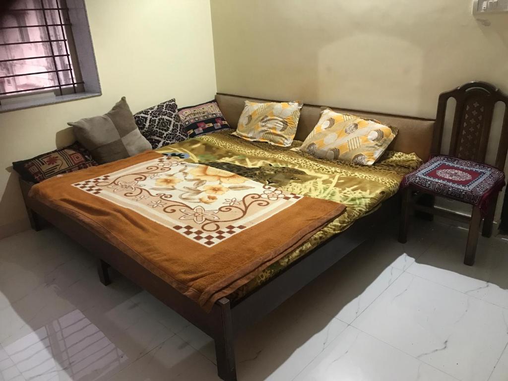 a bed in a room with a couch at Kushi guest house in Bangalore