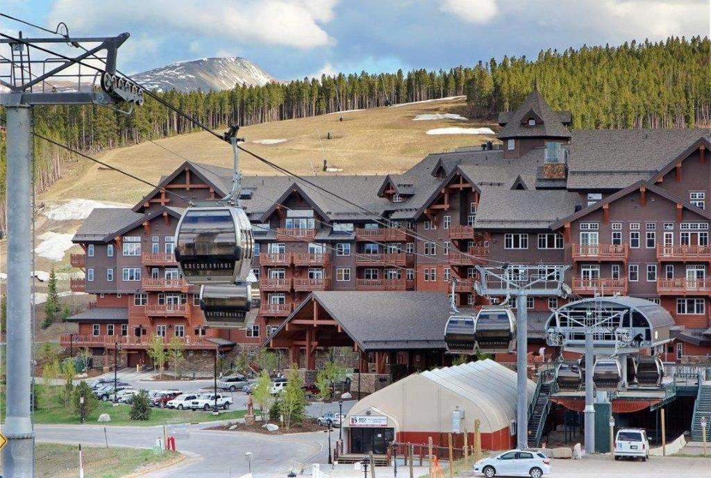 a ski lodge with a ski lift in front of it at One Ski Hill, A RockResort in Breckenridge