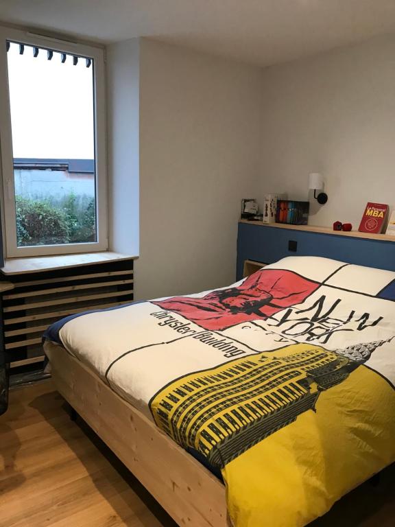 a bed in a bedroom with a window at Chambre Sallanches in Sallanches