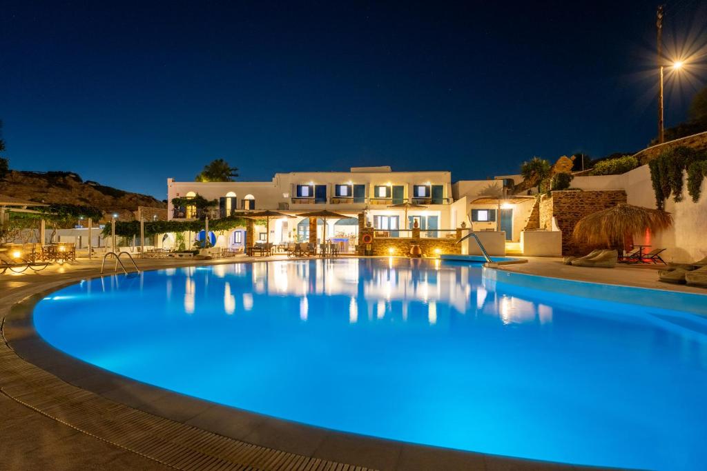- une grande piscine avec des lumières bleues la nuit dans l'établissement Fanari Art, à Ios Chora