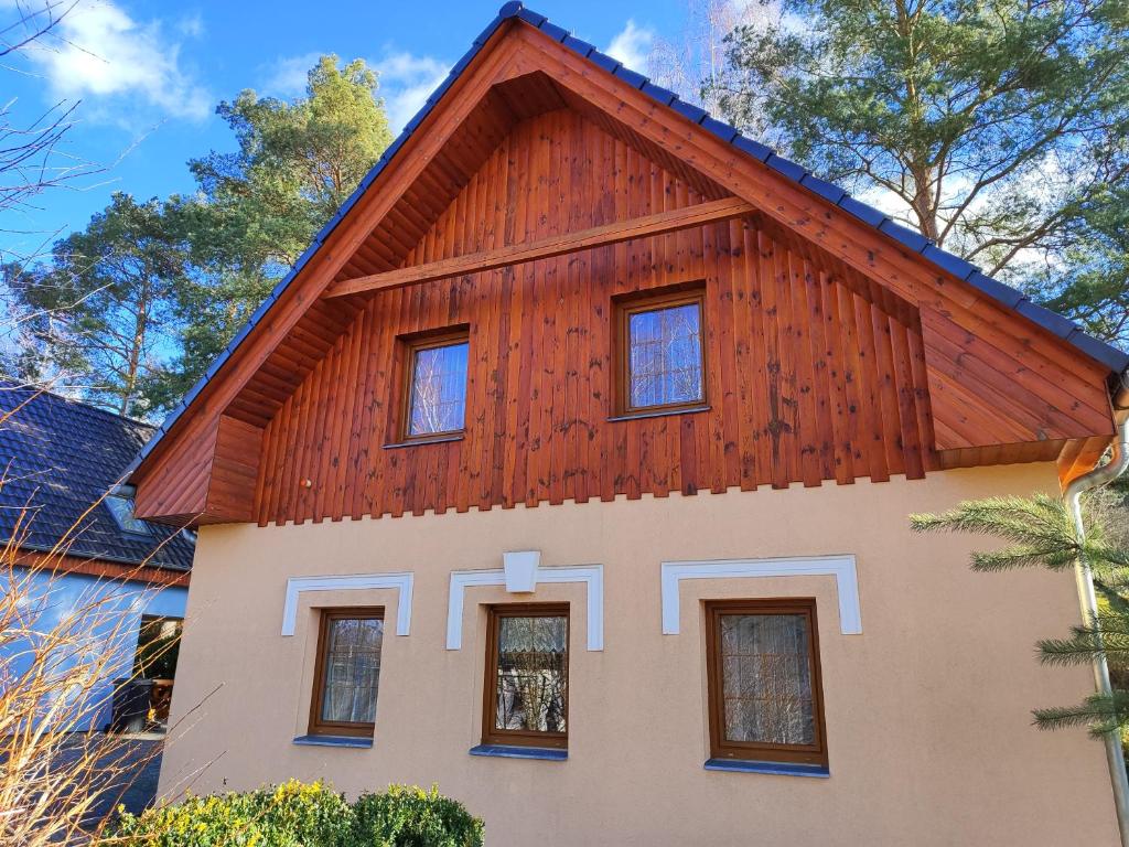 a house with a wooden roof at Resort Koloděje - oranžový dům in Koloděje nad Lužnicí