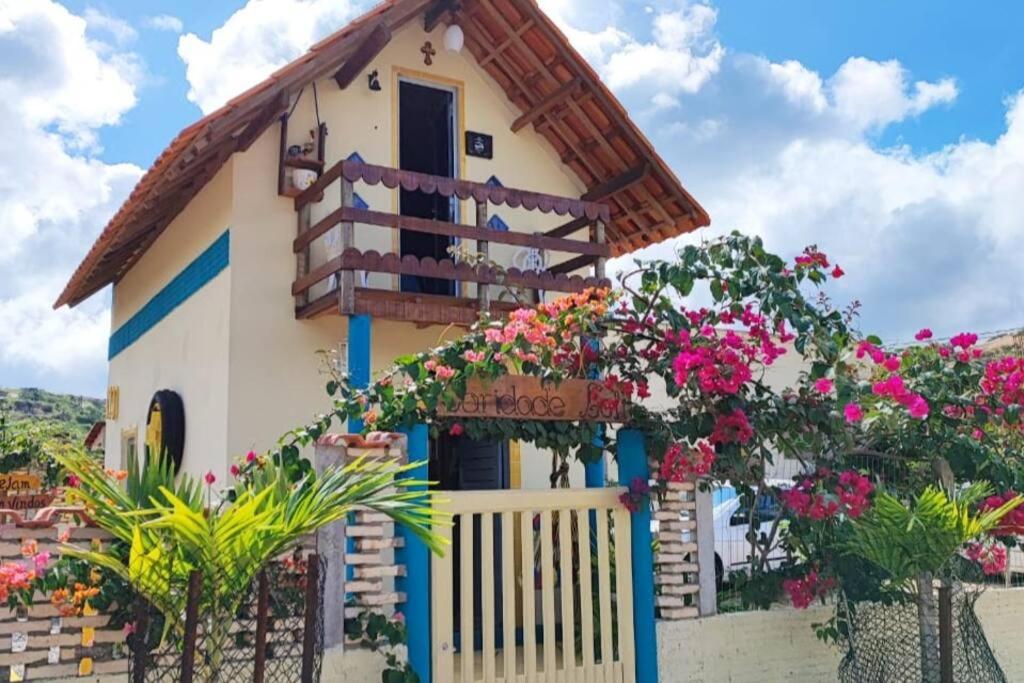 una casa con flores delante en Caridade Loft, en Monte das Gameleiras