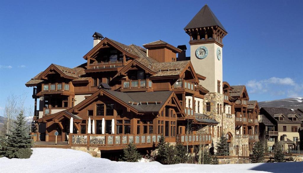 a large building with a clock tower in the snow at Arrowhead Village at Beaver Creek in Edwards