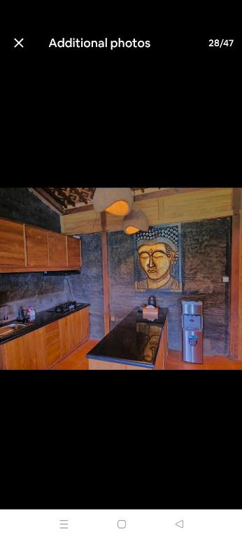 a kitchen with wooden cabinets and a counter top at Beyond Heaven in Tampaksiring