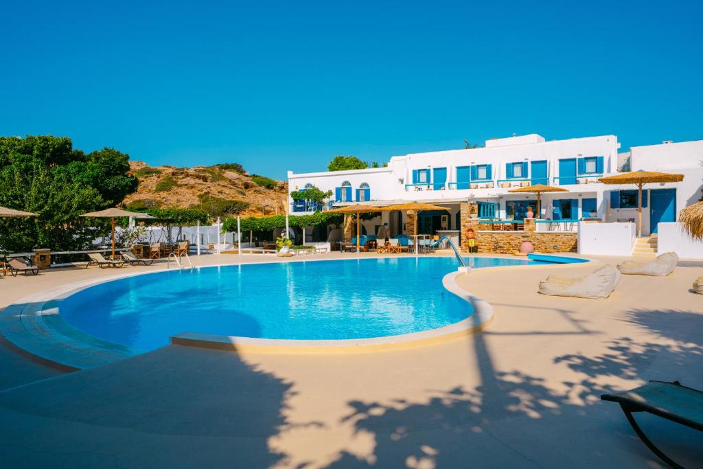 a swimming pool at a resort with white buildings at Fanari Art in Ios Chora