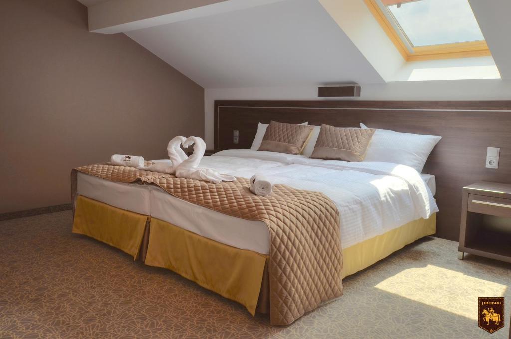 een slaapkamer met een groot bed en handdoeken bij CTKiR Browar Probus in Oława