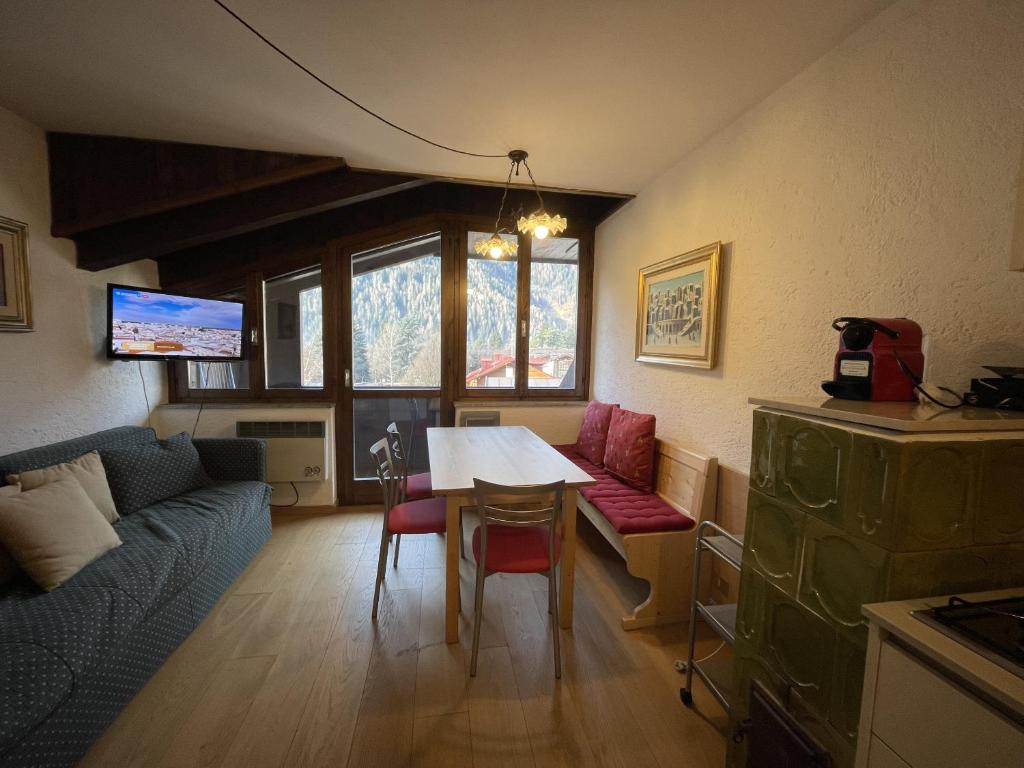 a living room with a table and a couch at 079 Bilocale, Pinzolo in Pinzolo