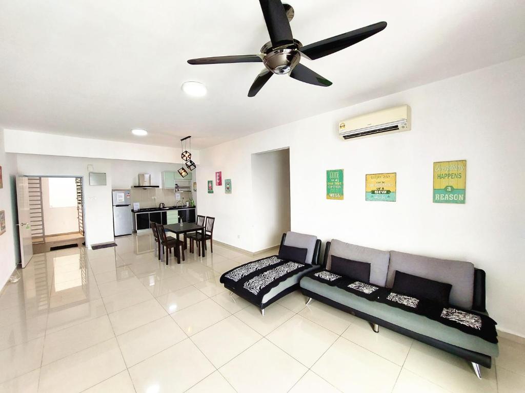a living room with a couch and a ceiling fan at SR28-HousePrivate-3room-BigHouse in Bayan Lepas