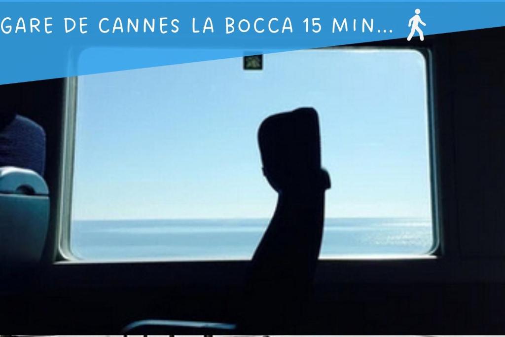 a silhouette of a person sitting in front of a window at Palais Belle Epoque - Property With Style in Cannes