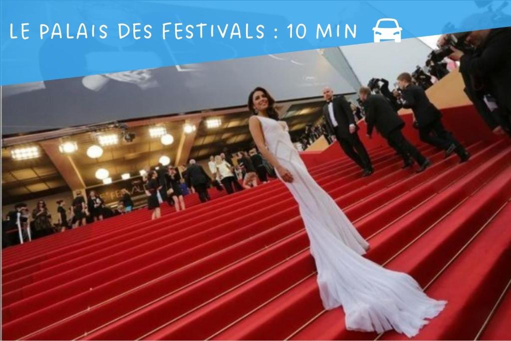 a woman in a white dress on a red carpet at Palais Belle Epoque - Property With Style in Cannes