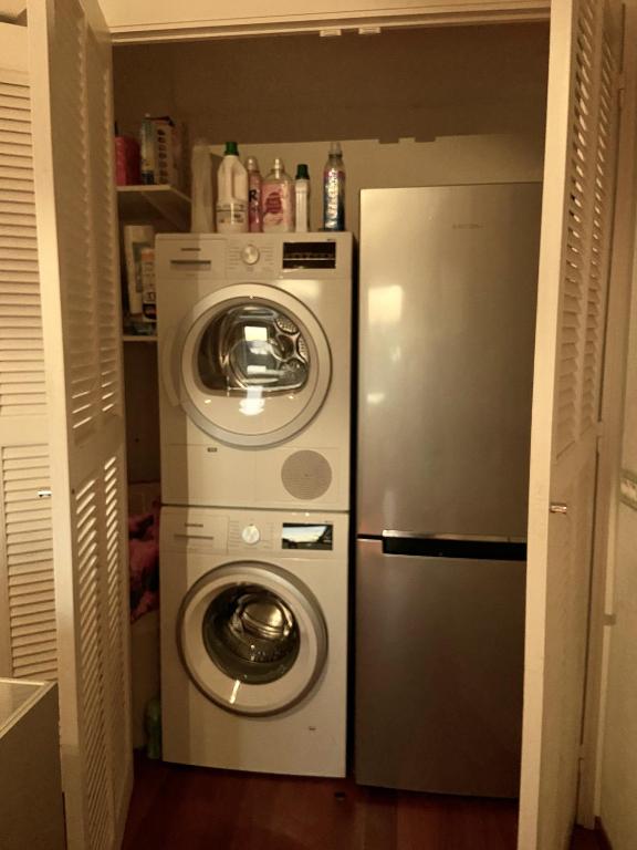 a washer and dryer in a small room with a refrigerator at Palais Belle Epoque - Property With Style in Cannes