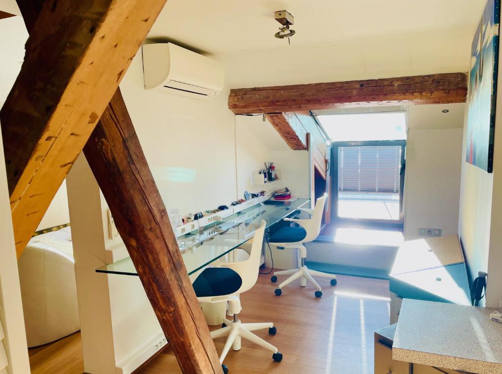an attic office with blue chairs and a desk at Palais Belle Epoque - Property With Style in Cannes