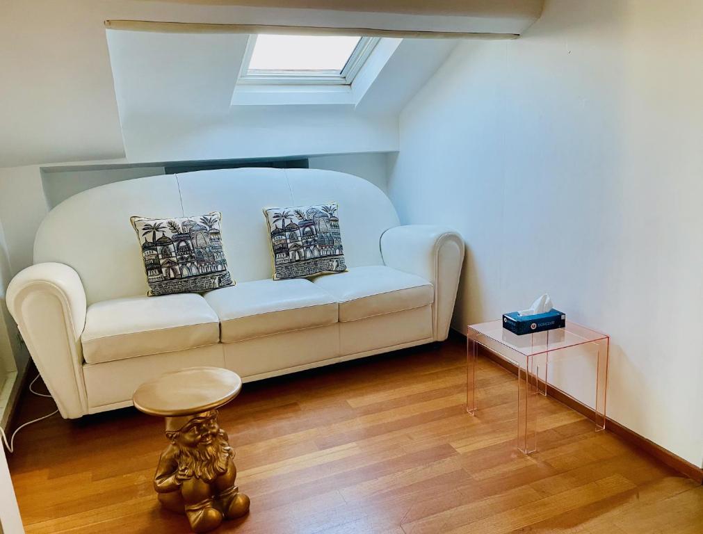 a living room with a white couch and a table at Palais Belle Epoque - Property With Style in Cannes