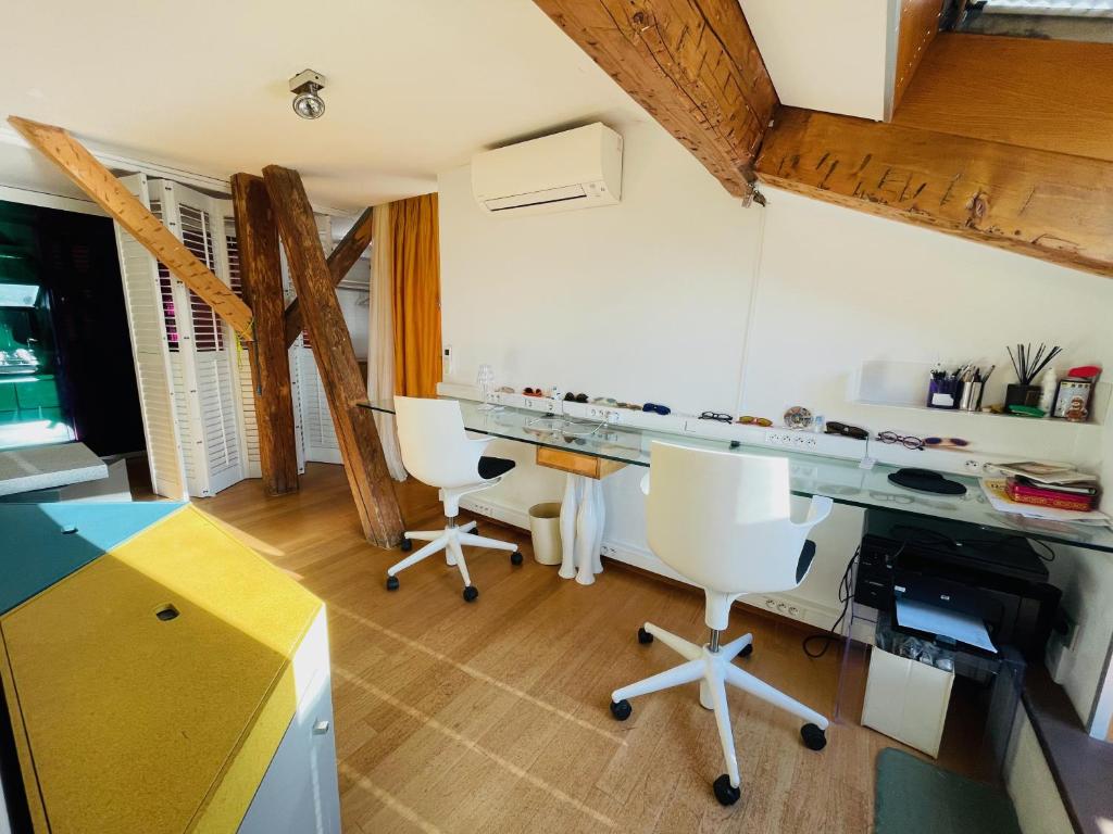 a kitchen with a desk and chairs in a room at Palais Belle Epoque - Property With Style in Cannes