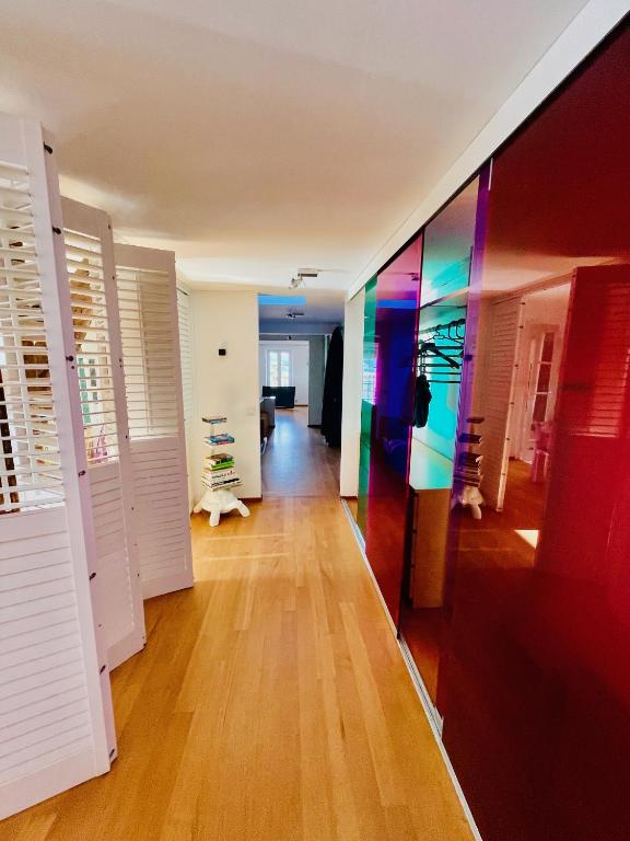 a hallway with white doors and a colorful wall at Palais Belle Epoque - Property With Style in Cannes