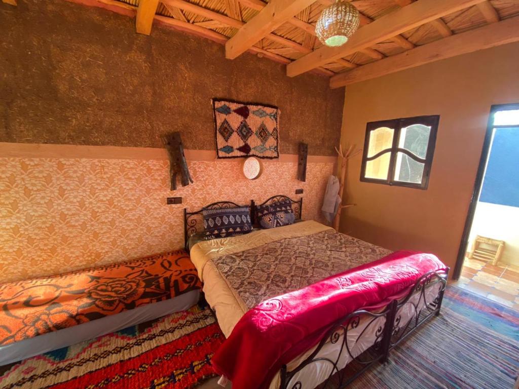 a bedroom with a bed and a couch in it at riad jnane imnane in Tamguist