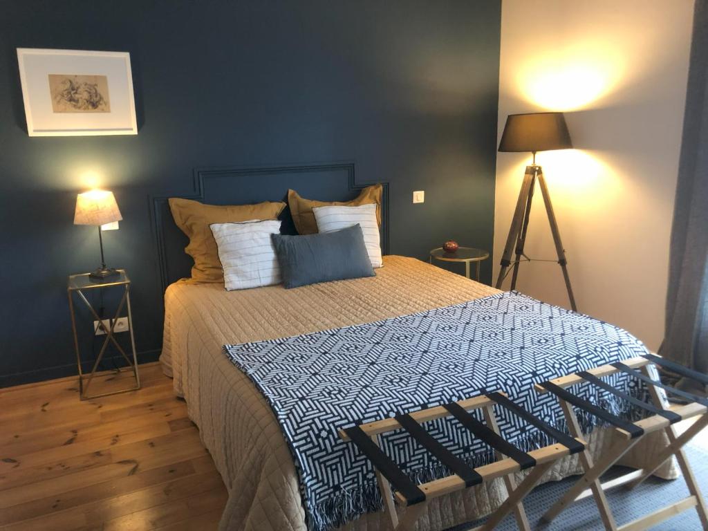 1 dormitorio con 1 cama grande y paredes azules en La Mulonniere, en Saint-Sébastien-sur-Loire