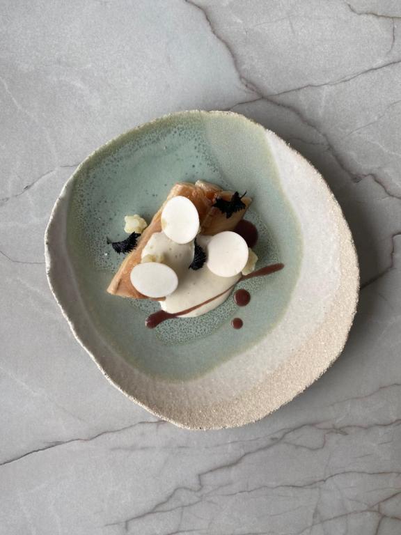 a piece of food on a plate on a table at Hôtel Restaurant La Ferme de Cupelin in Saint-Gervais-les-Bains