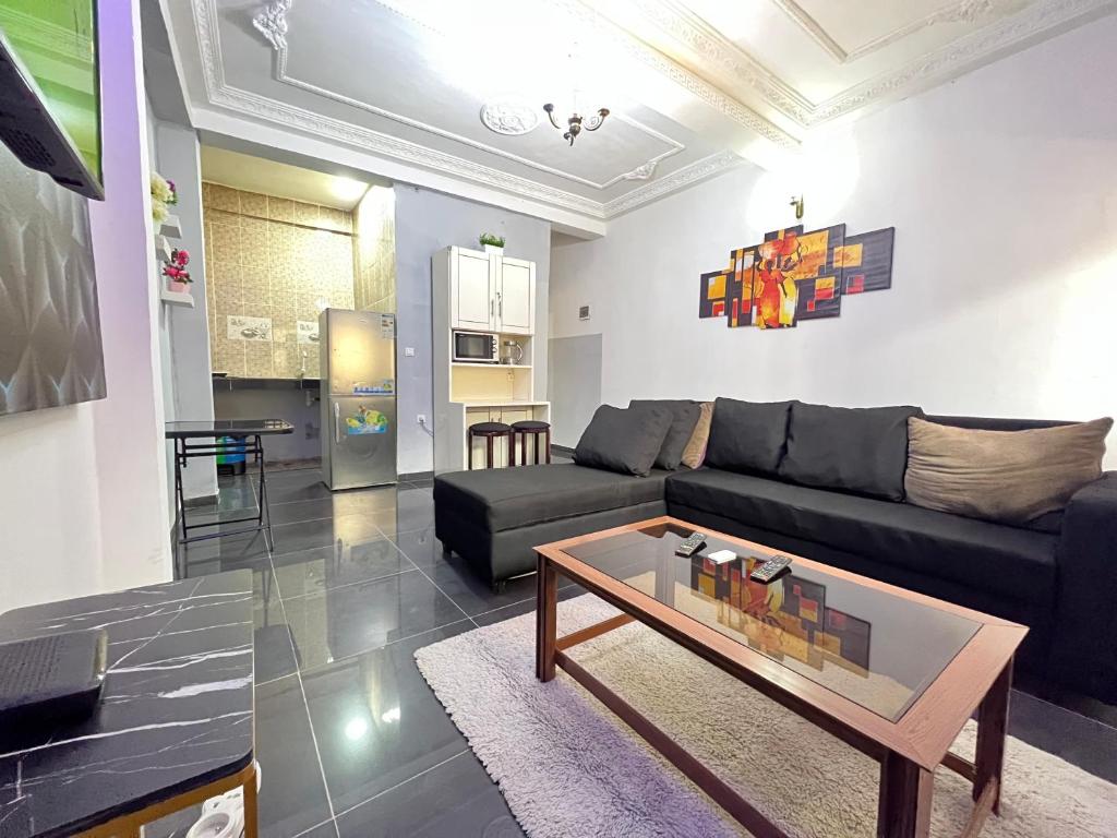 a living room with a couch and a coffee table at The Yafé Bastos 13 in Yaoundé
