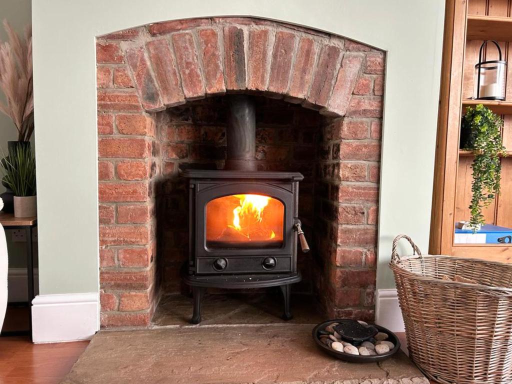 a stove in a brick fireplace in a room at Beautiful 3 Bedroom House in Chester Le Street in Chester-le-Street