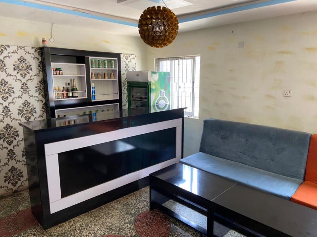 a living room with a large television and a couch at ClinClia Hotel2 in Ibadan
