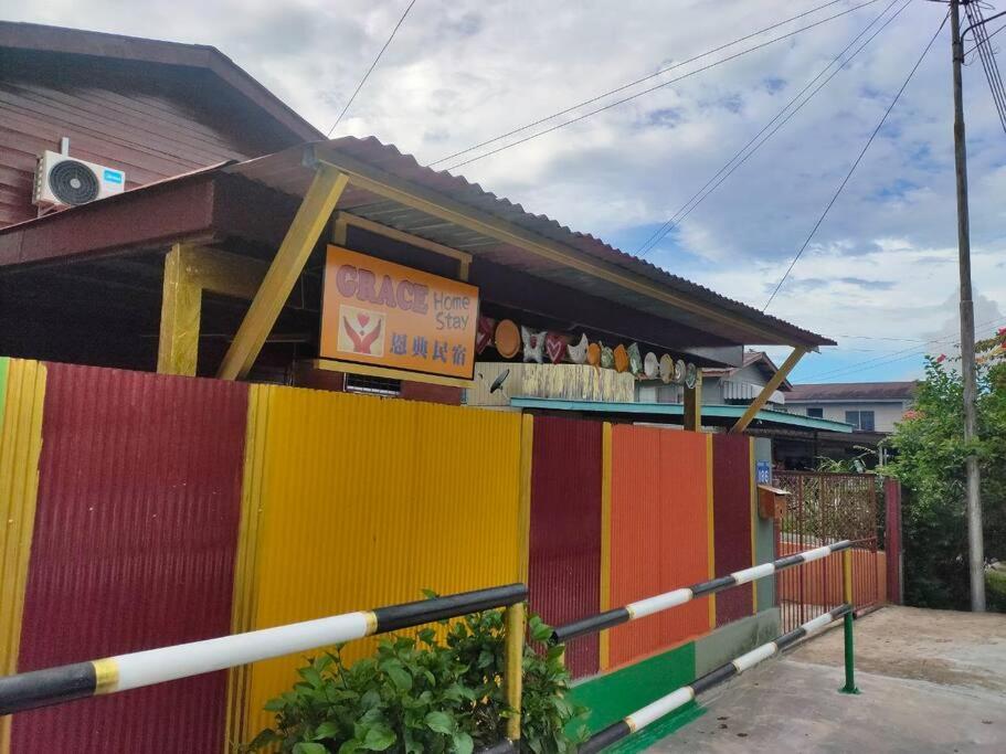 a colorful building with a sign on top of it at Grace Homestay Kepayan in Kota Kinabalu