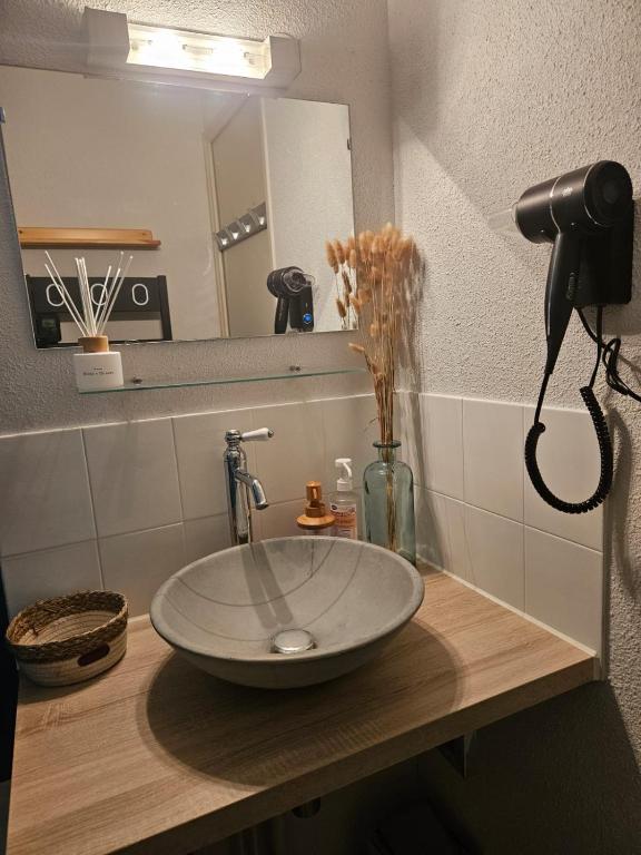 a bathroom counter with a sink and a mirror at Aux pieds des pistes en plein soleil in Les Contamines-Montjoie