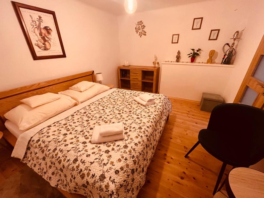 a bedroom with a bed with two towels on it at Chalupa U Franze in Malá Morava