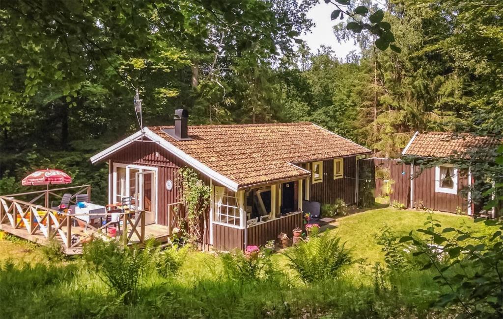 a small house in the middle of a yard at Amazing Home In Hr With Kitchen in Höör