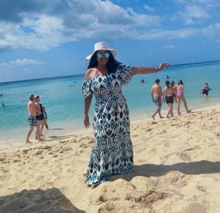 a woman is standing on the beach at Tropical Beach Bayahibe in Bayahibe