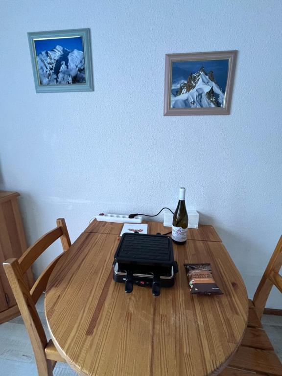a wooden table with a laptop on top of it at Aux pieds des pistes en plein soleil in Les Contamines-Montjoie