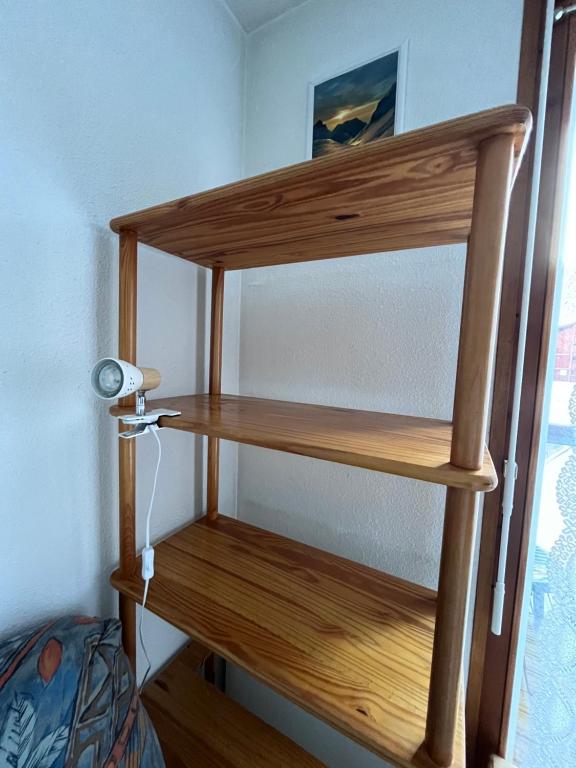 a wooden shelf in a room with a lamp at Aux pieds des pistes en plein soleil in Les Contamines-Montjoie