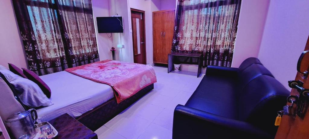 a small bedroom with a bed and a chair at Shillong Guest House in Shillong