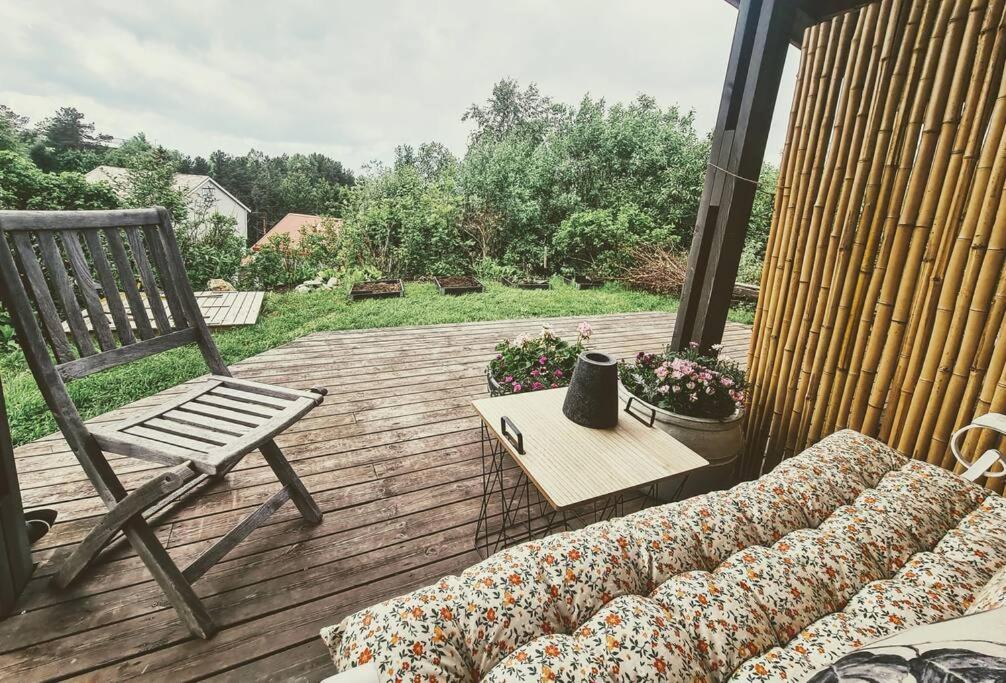 a patio with a couch and a chair on a deck at Cosy Holiday Apt Close to Gondola and Town Center in Narvik