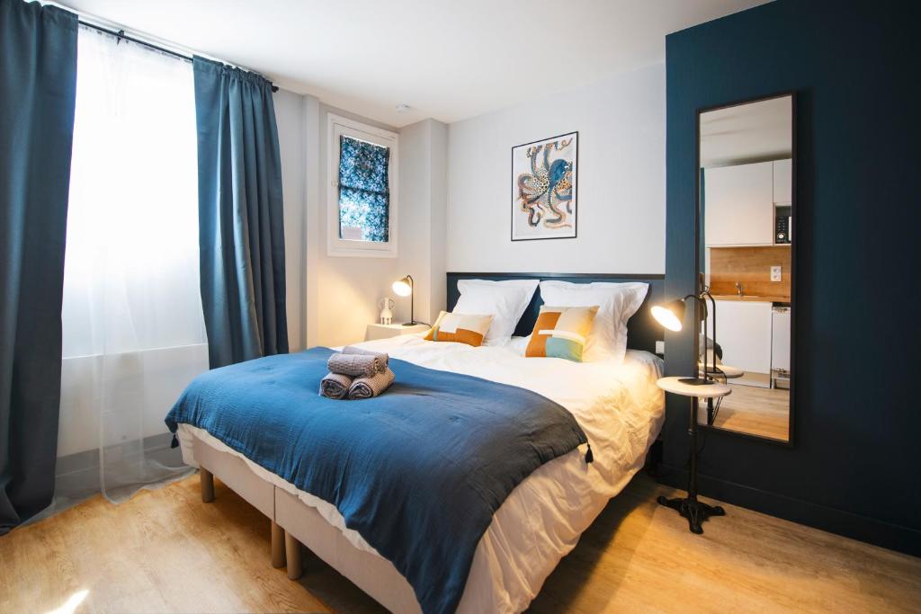 een slaapkamer met een groot bed met een teddybeer erop bij Studio détente en hypercentre, Cathédrale in Orléans
