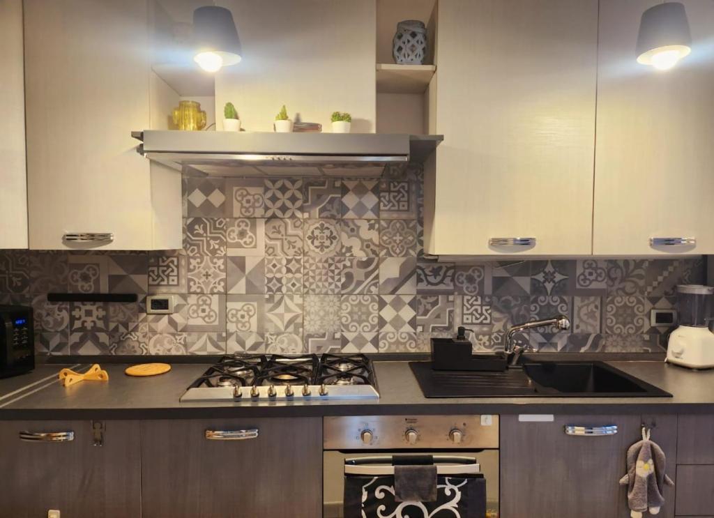 a kitchen with a stove and a sink at Villa Valentina in Madonna dellʼAcqua