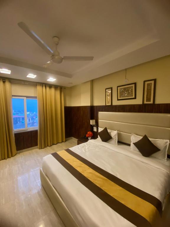 a bedroom with a large bed and a window at MJ Hills Rishikesh in Rishīkesh