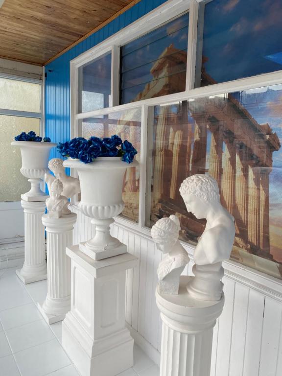 a group of white statues in front of a window at The New Athena Hotel in Blackpool