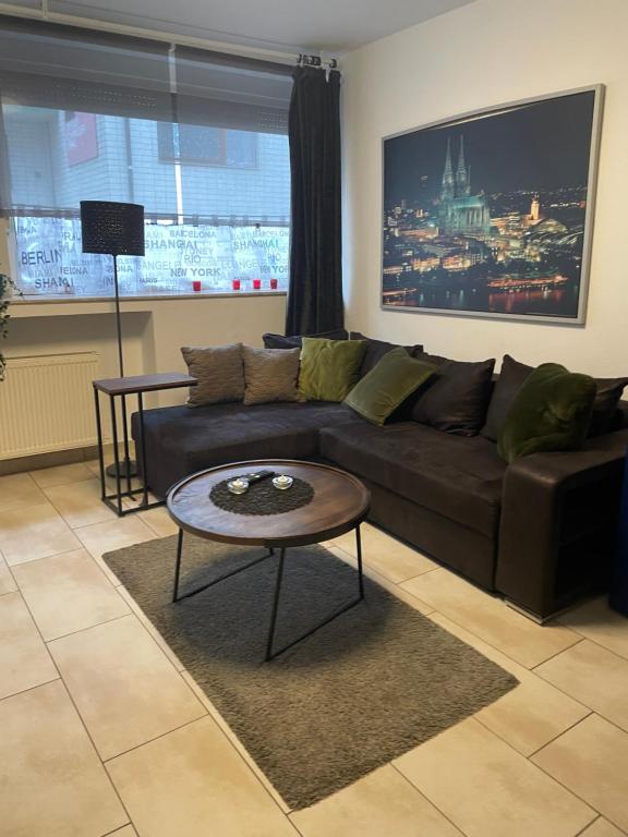 a living room with a couch and a coffee table at Köln Apartment I in Cologne