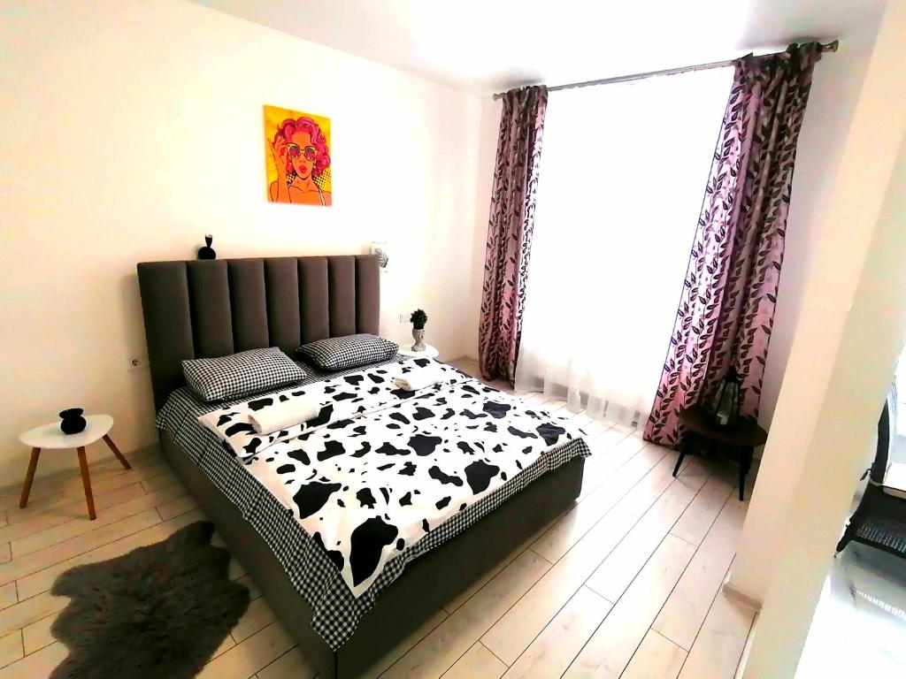 リヴィウにあるНовобудова сам центр ЖК "Семицвіт"のベッドルーム(白黒の牛が寝室に寝室に寝室に寝室に寝室に寝室に寝室に寝室が付いています。