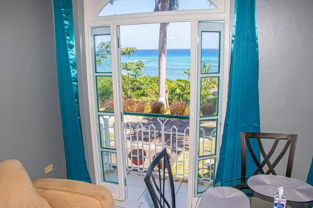 a room with a window with a view of the ocean at Malibu Ocean View Studio in Montego Bay