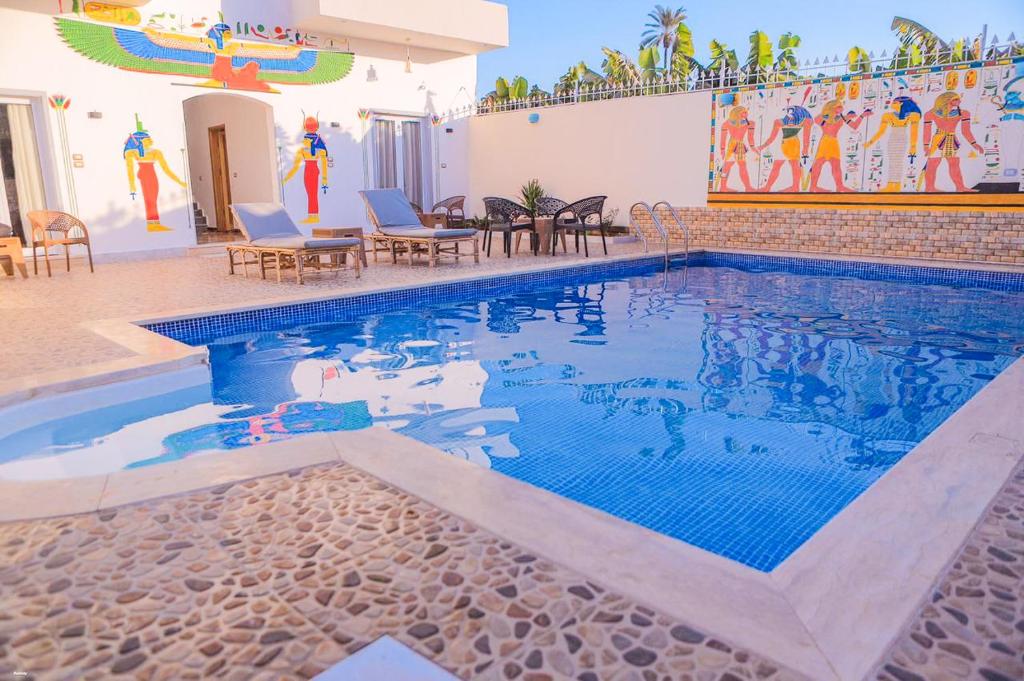 a swimming pool in the middle of a house at Villa Desert Rose in Luxor