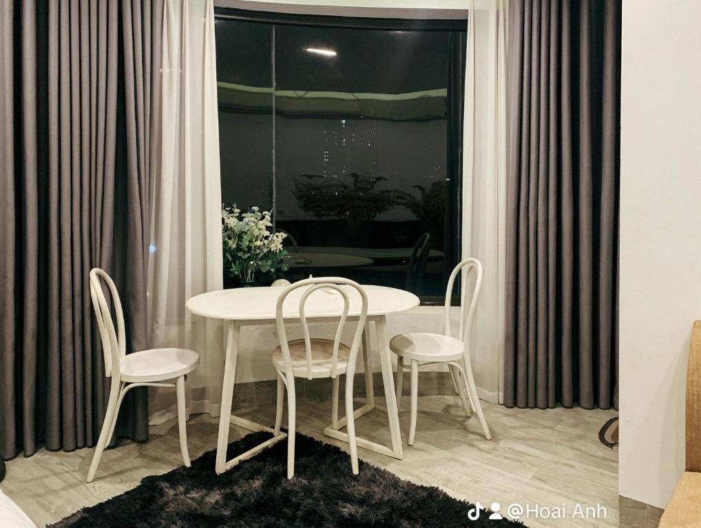 a white table and chairs in a room with a window at Green Line Long Bien - Serviced Apartment - Ngoc Thuy - Hanoi in Hanoi