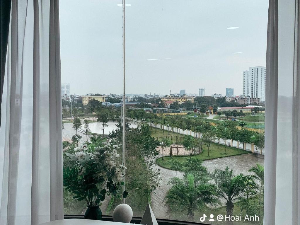 a room with a window with a view of a park at Green Line Long Bien - Serviced Apartment - Ngoc Thuy - Hanoi in Hanoi