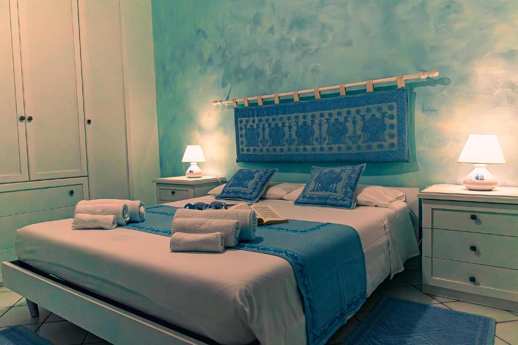 1 dormitorio con 1 cama grande y toallas. en Casa del Campanil en Alghero