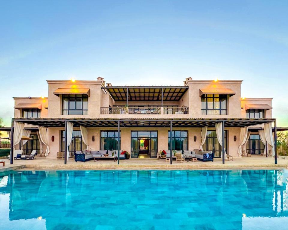 an exterior view of a house with a swimming pool at Al Destino Villa Riad Spa Luxury Marrakech in Marrakech