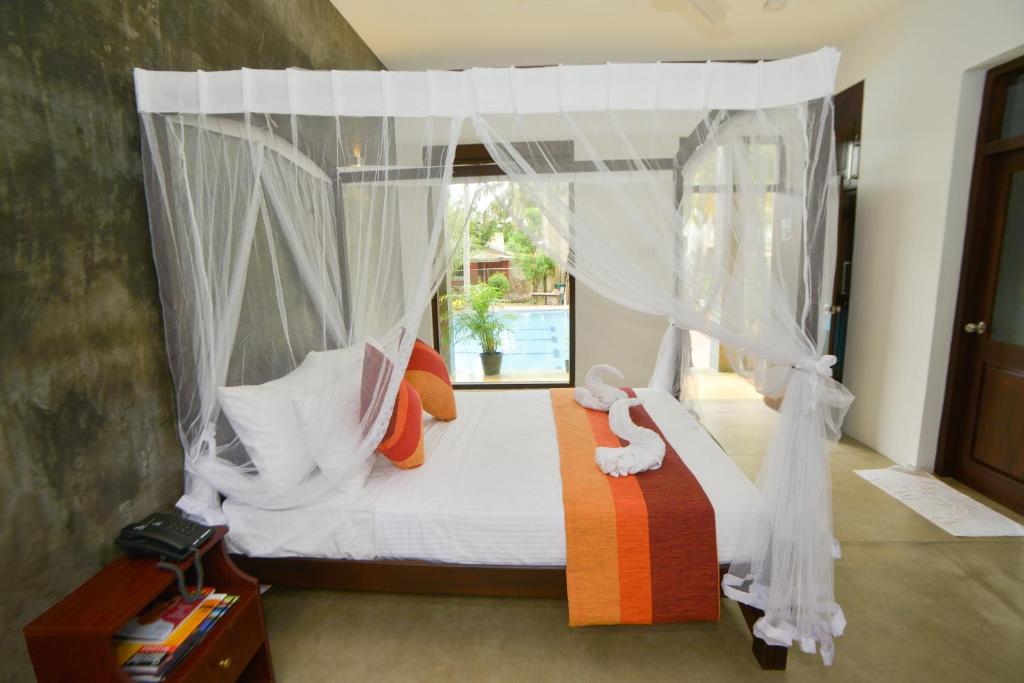 Postel nebo postele na pokoji v ubytování Olanro Hotel Negombo