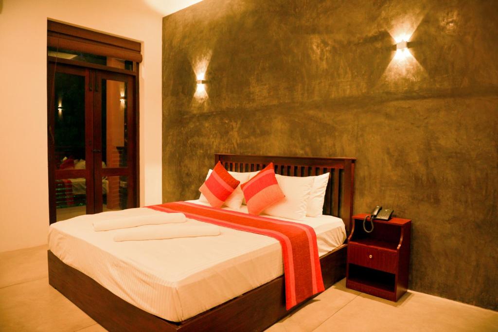 Postel nebo postele na pokoji v ubytování Olanro Hotel Negombo