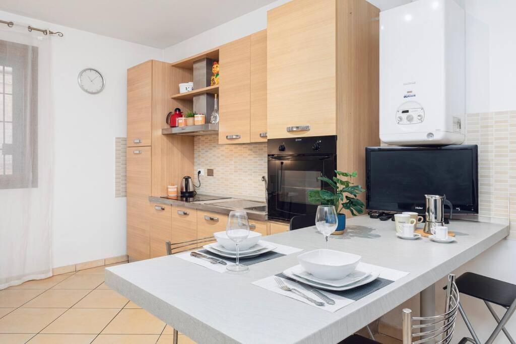 a kitchen with a large white island in a room at Loft - Comfort Studio - [10m Piazza Maggiore] in Bologna