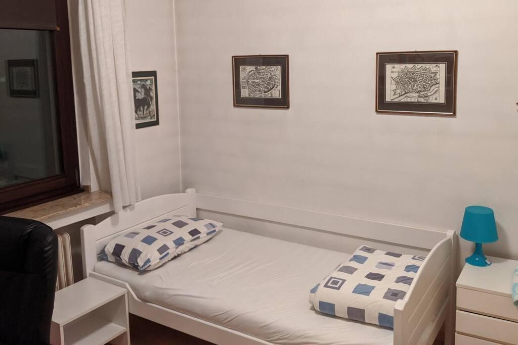 a room with a bed with two pillows on it at Praktisches Gästezimmer für eine Person in Bergisch Gladbach